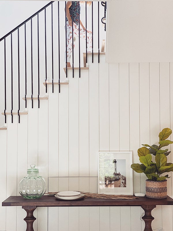 Artifact Uprising Gallery Frame in white on console table in front of staircase wall