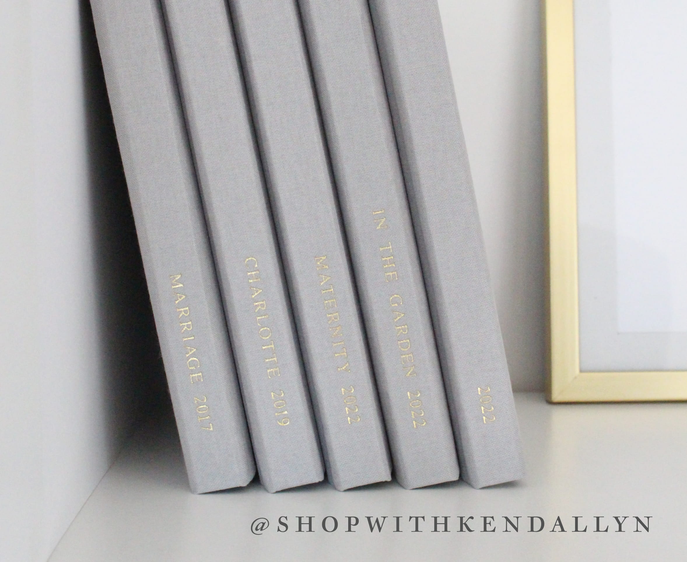image of yearly layflat photo albums on display in bookshelf