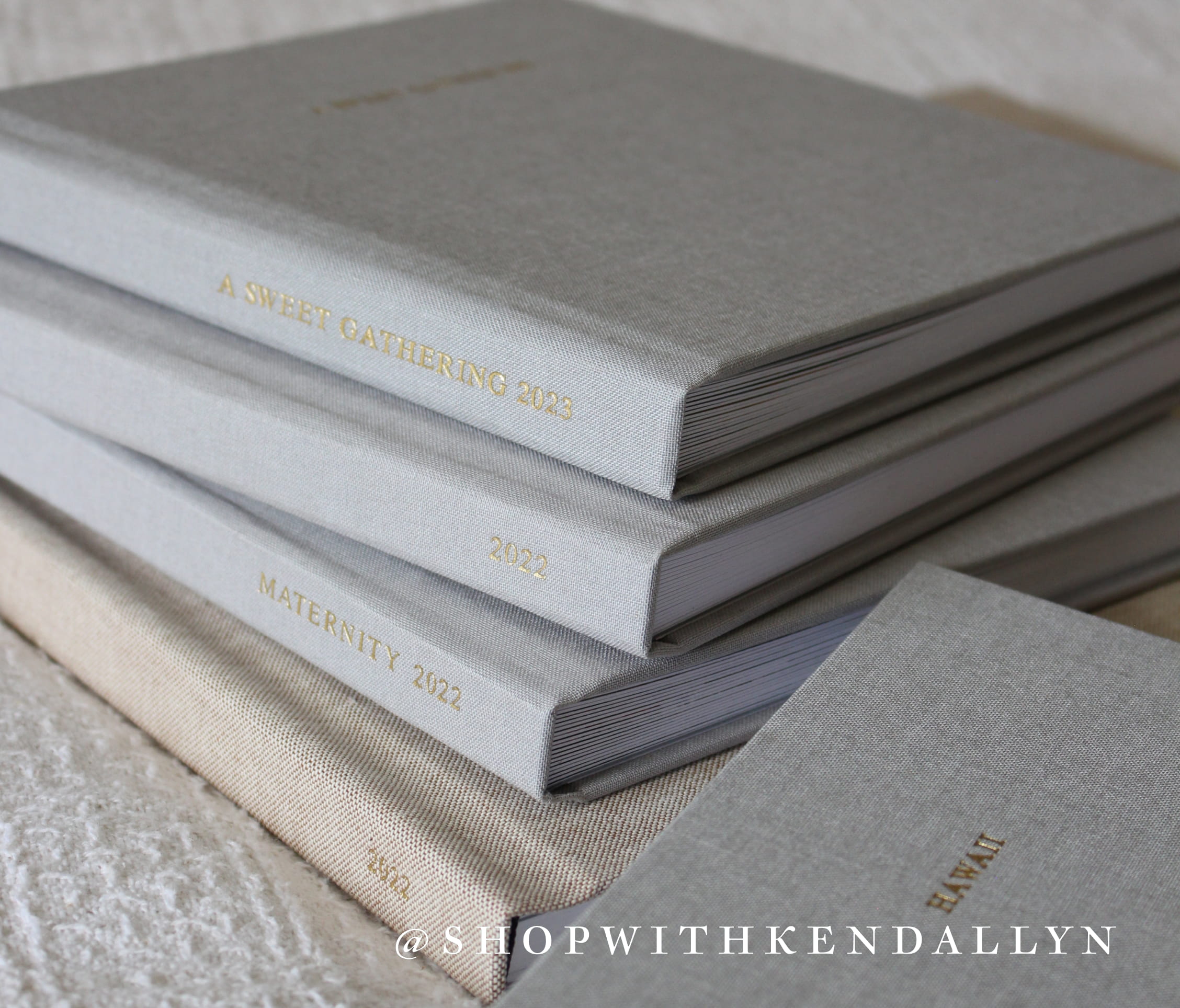 image of yearly layflat photo albums stacked showcasing all the yearly albums made