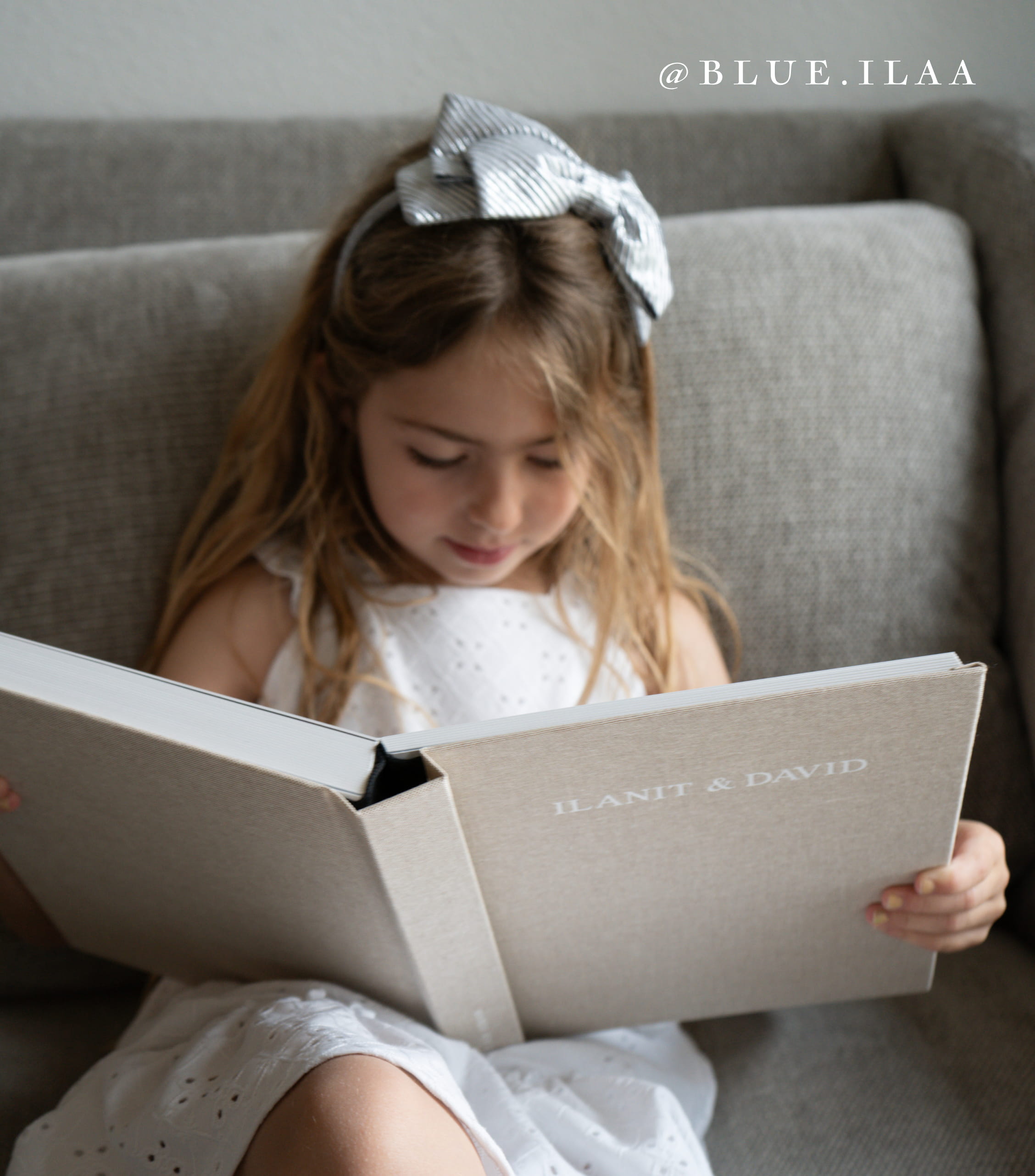 little girl flipping through a layflat photo album